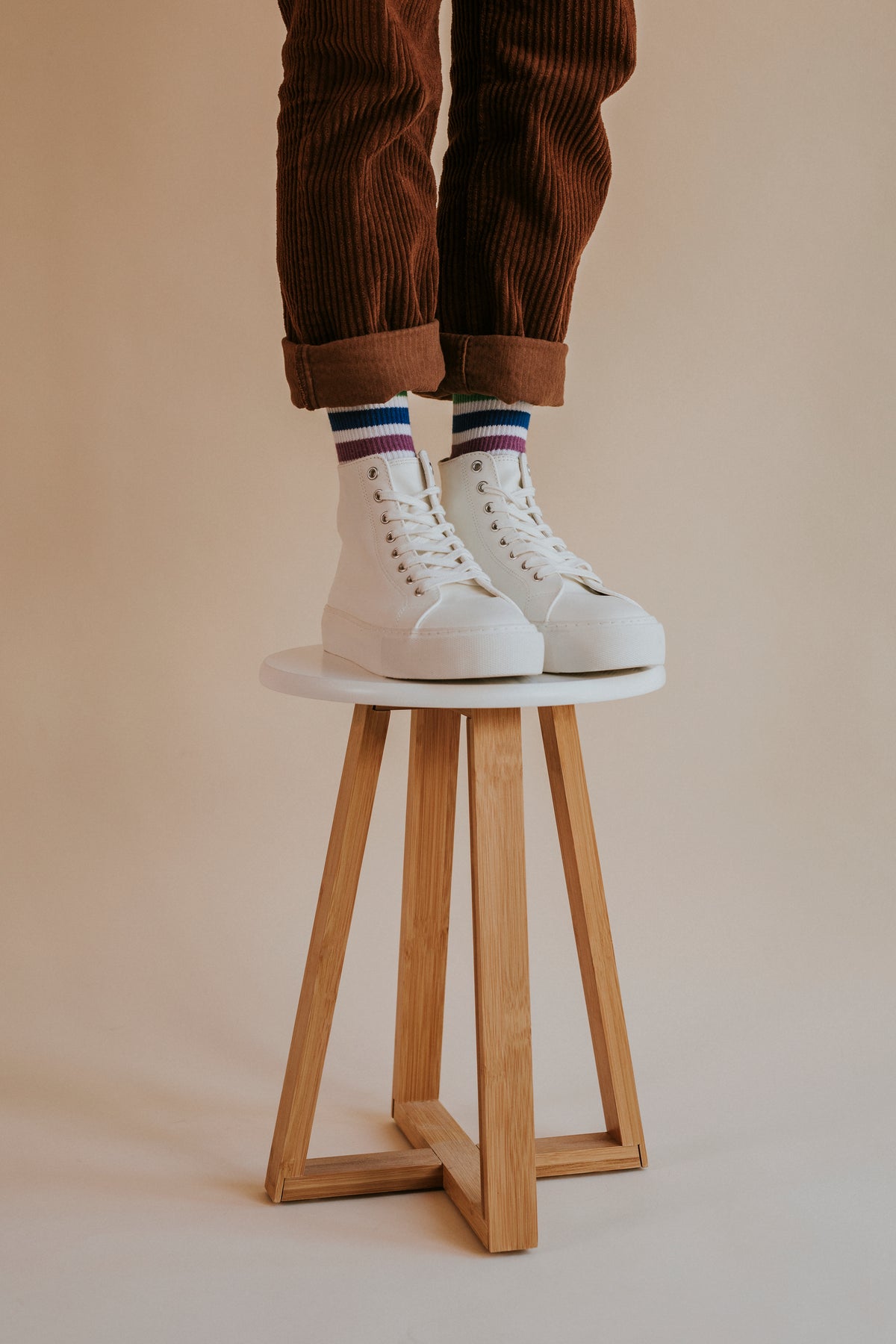 White high-top sneakers on a stool